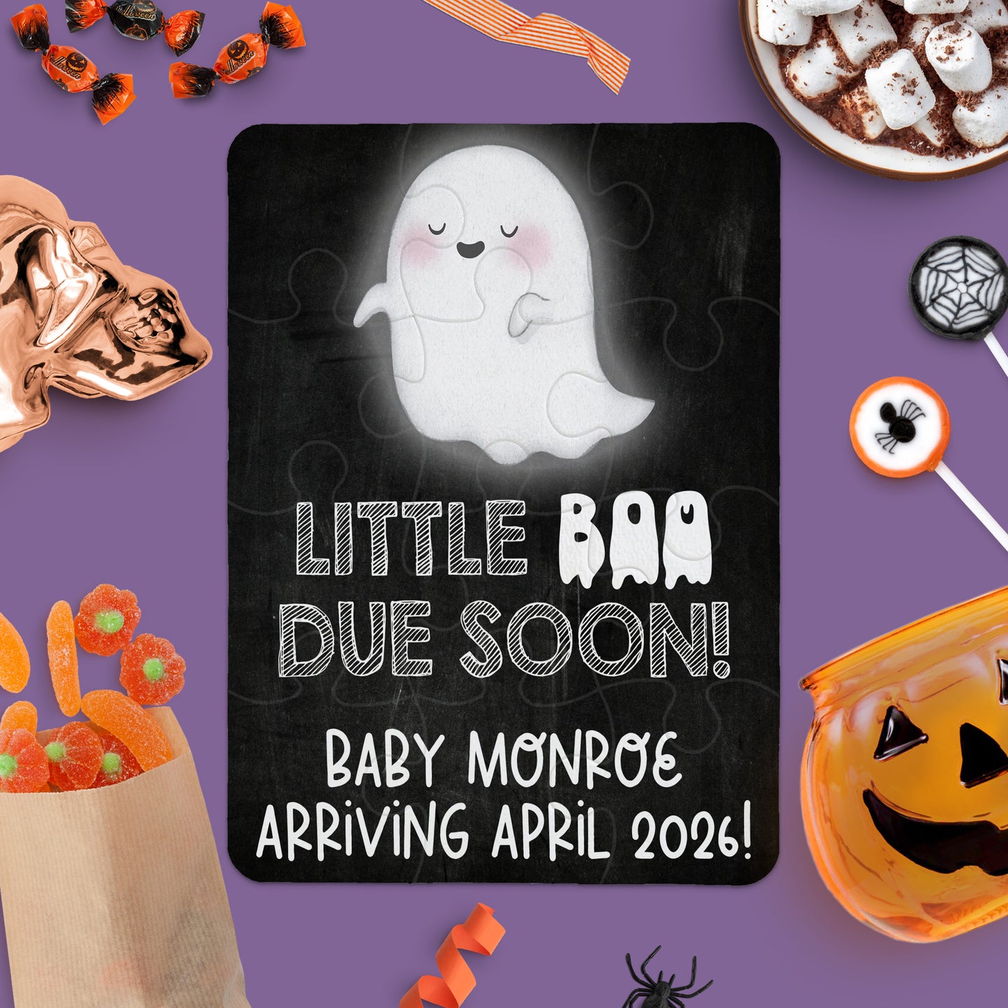 A ghost-themed puzzle with the text âLittle Boo Due Soon! Baby Monroe Arriving April 2026!â surrounded by Halloween treats and decorations on a purple background.