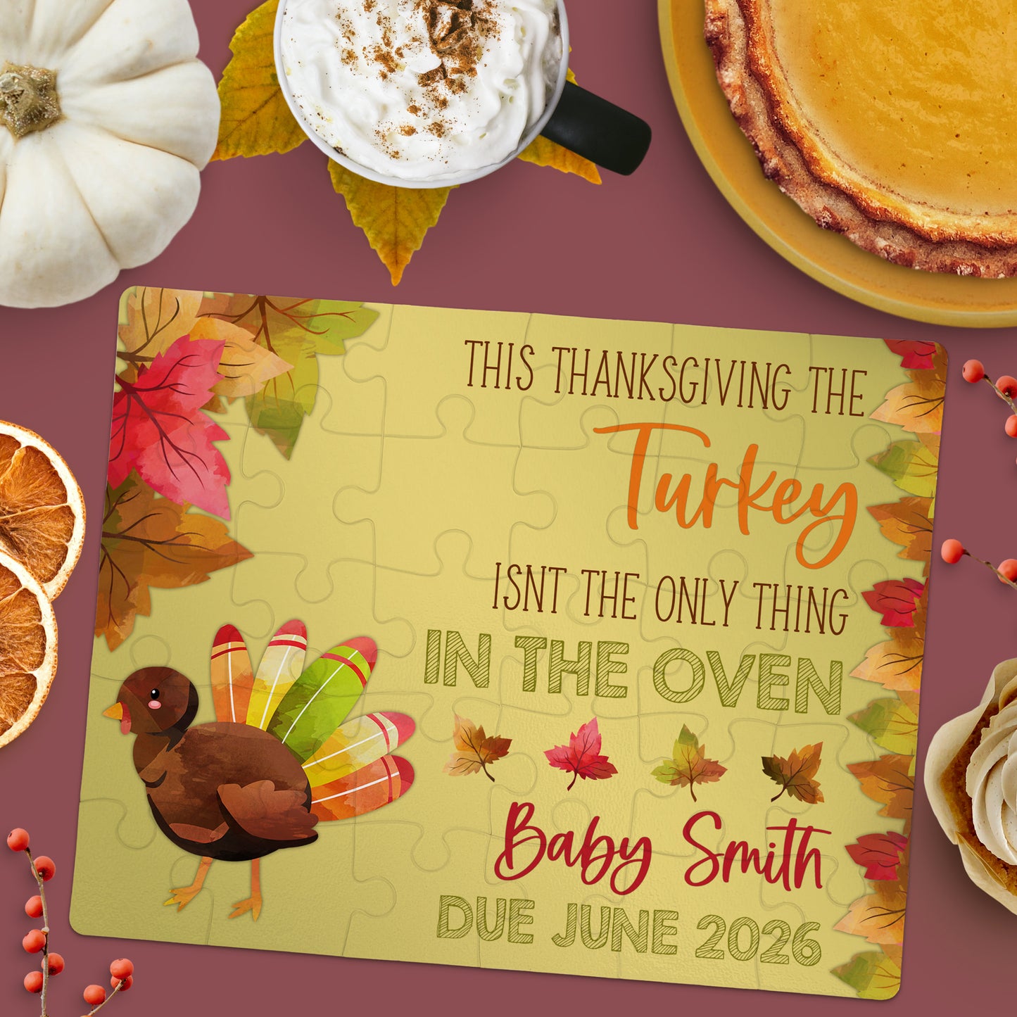A jigsaw puzzle with a turkey graphic and text announcing a pregnancy, surrounded by autumn items like leaves, pie, coffee, and a pumpkin.