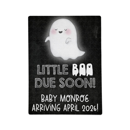 A puzzle with a cartoon ghost and the text: "Little Boo Due Soon! Baby Monroe Arriving April 2026!" on a black background.