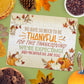 A puzzle on a table reads, "We have so much to be thankful for this Thanksgiving! We're expecting! Baby MacArthur due June 2026!" surrounded by autumn-themed items.